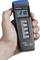 A hand is holding a digital thermometer displaying '21°C'. Beneath it are buttons for various measurement functions.