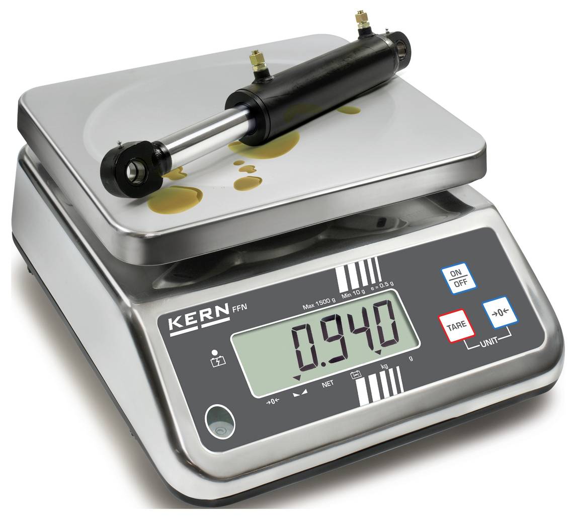 A digital scale shows a weight of 0.940 kg. A black cylindrical object is resting on the scale.