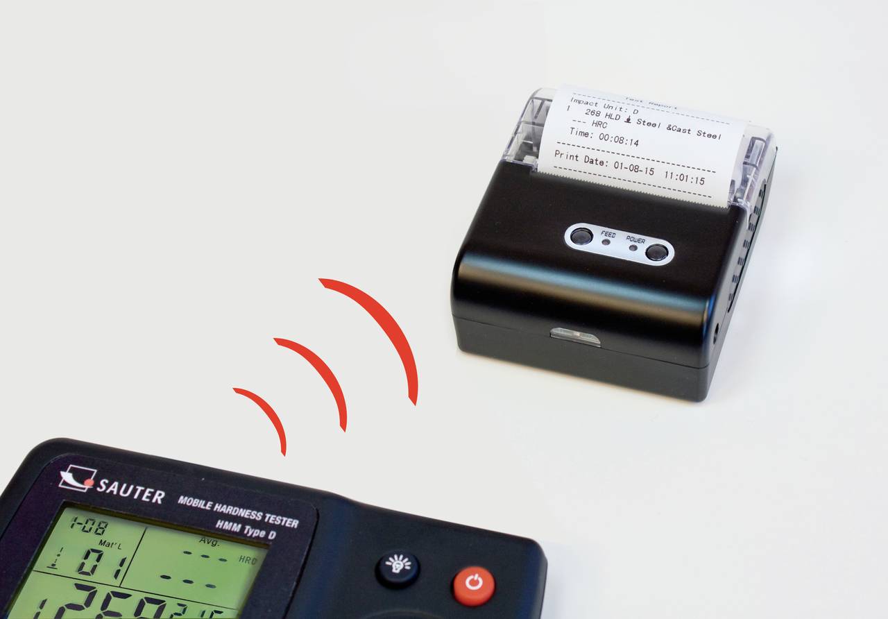 A mobile hardness testing device displays measurement values on a screen, which are wirelessly transmitted to a compact printer that prints the data.