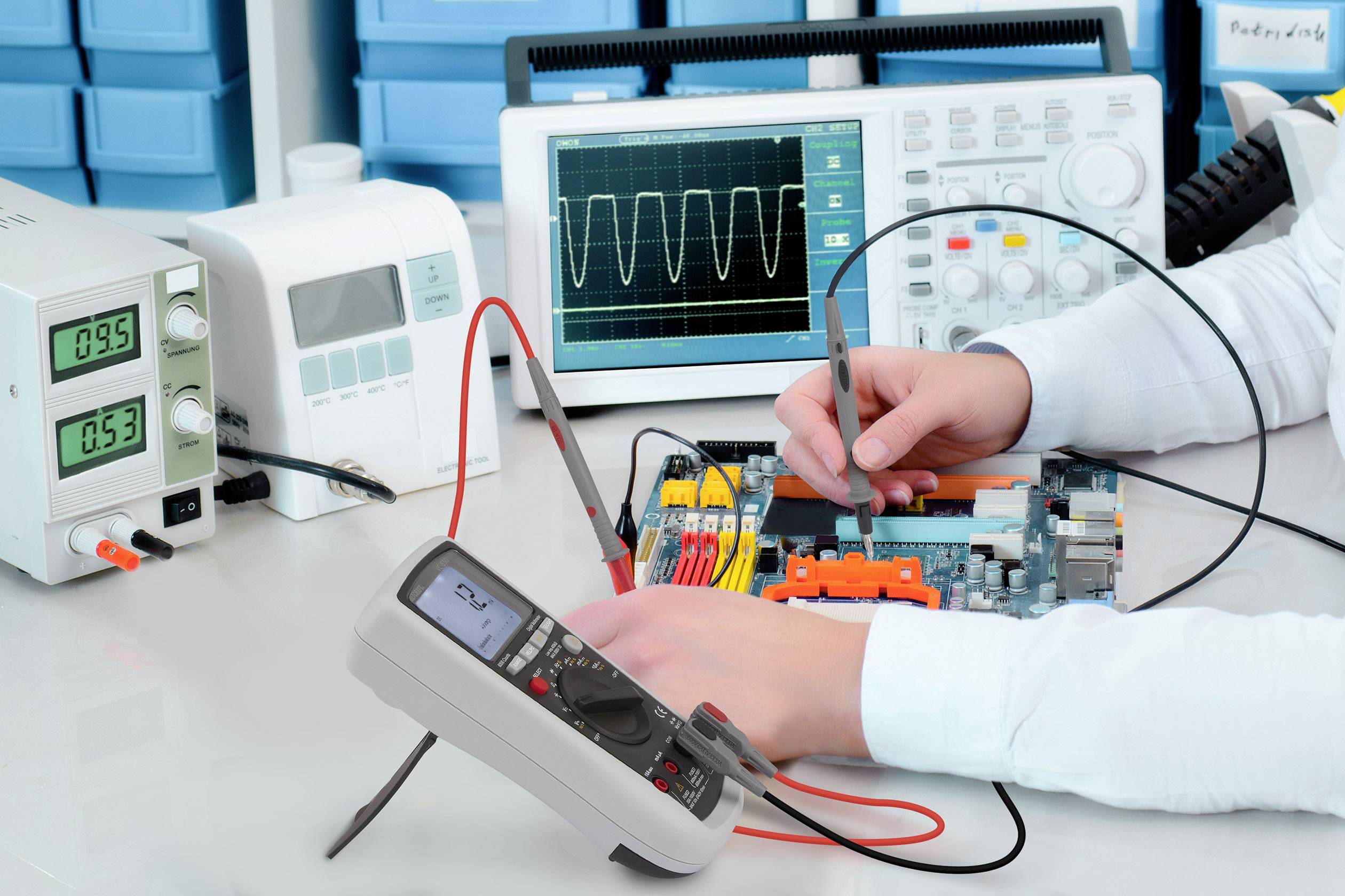 A person is testing an electronic circuit board with a multimeter and oscilloscope to check voltage and signal values.