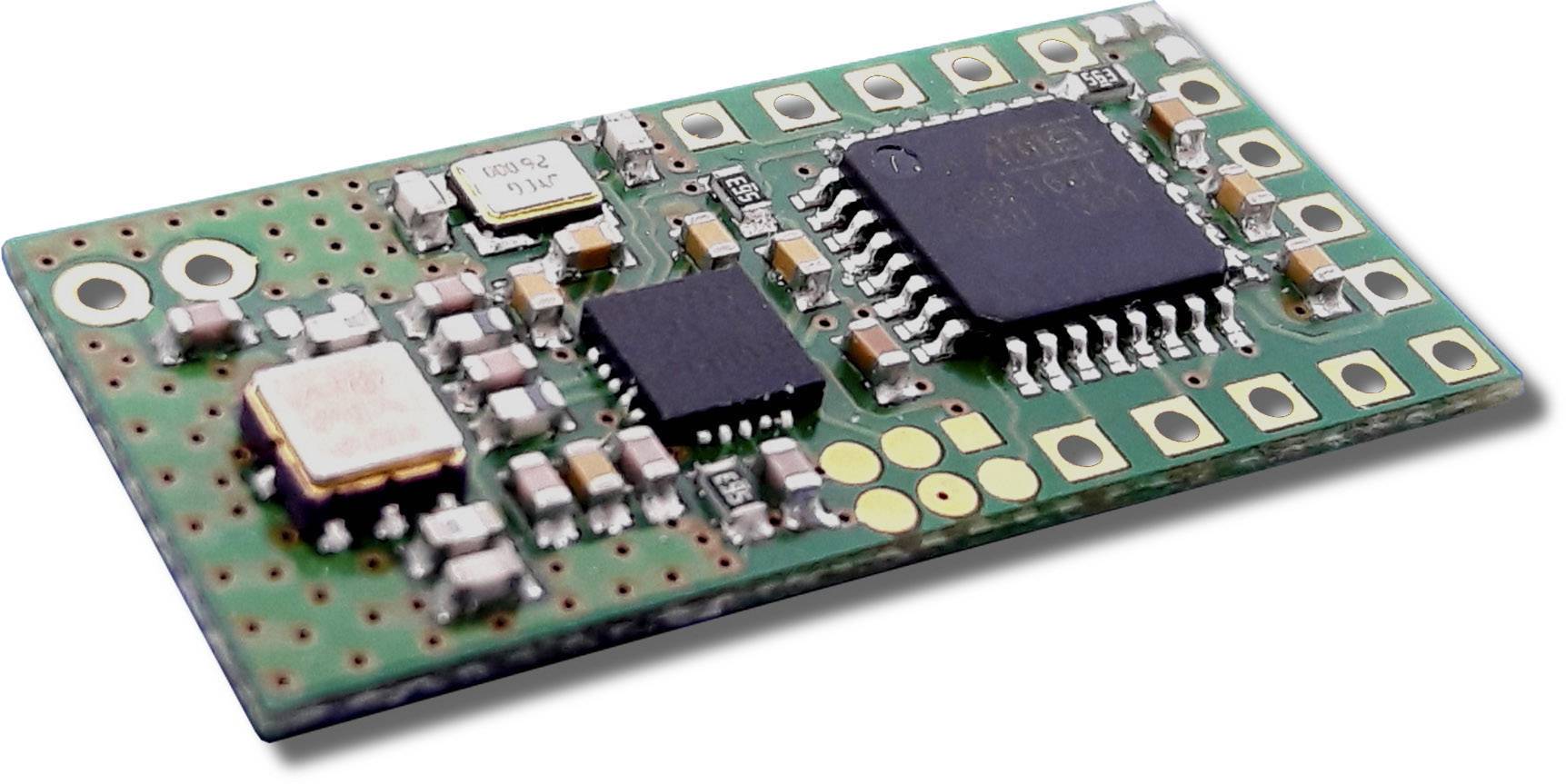 A microcontroller on a circuit board with multiple small electronic components, including chips and capacitors.
