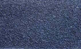 Dark pebble or gravel pattern in a close-up, depicting a rough texture or surface.