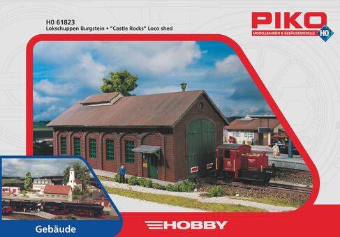 Model train set packaging featuring the 'Castle Rocks' loco shed. Shows a red locomotive next to a detailed HO scale building.