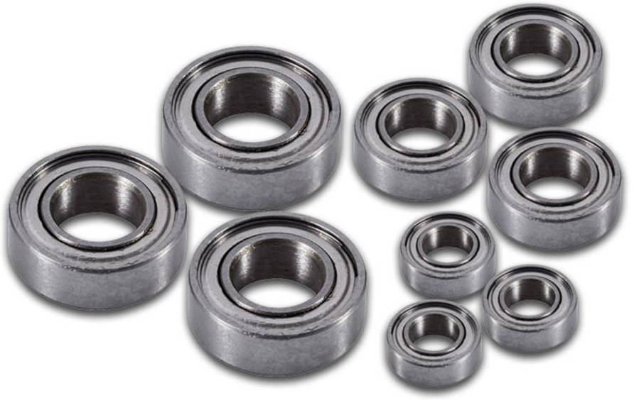 Eight metal ball bearings of various sizes on a white background, suitable for mechanical applications and machine parts.