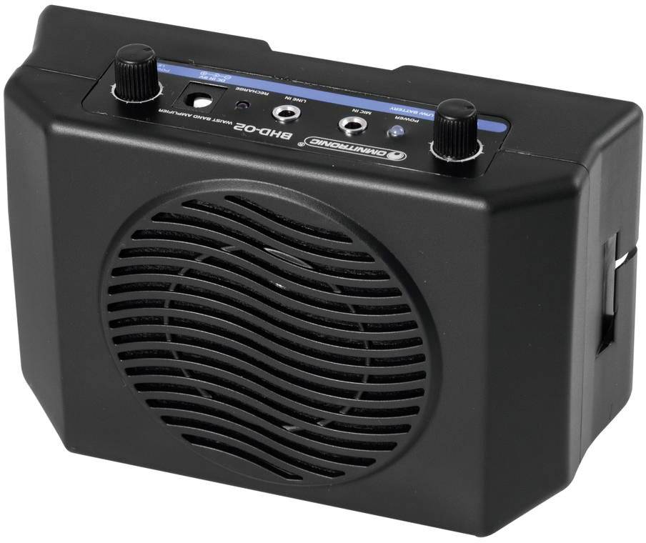 Black portable speaker with two knobs and multiple connections on the top.