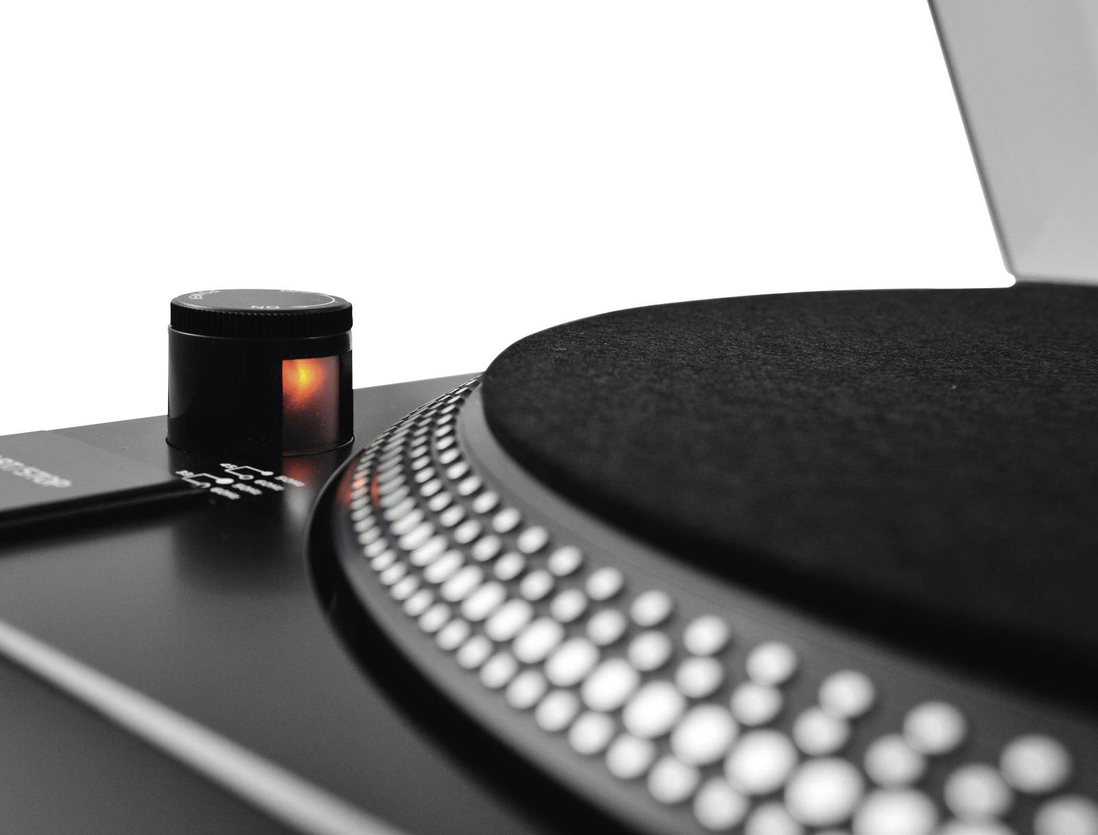 Record player close-up with a glowing button, focused on the turntable with a dotted pattern.