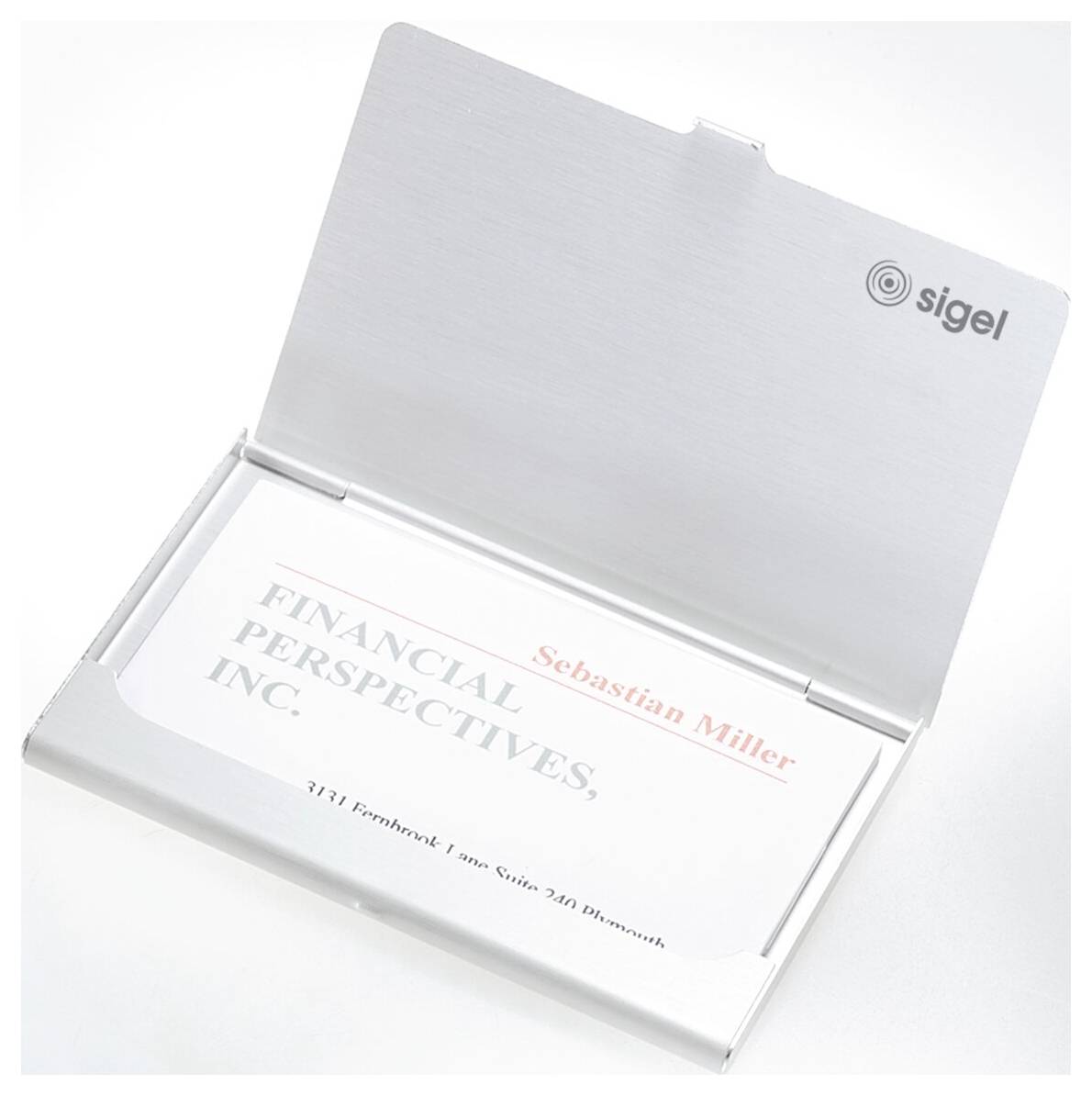 Open silver presentation box displaying a business card reading 'Financial Perspectives, Inc.' with 'Sebastian Miller' and the Sigel logo on the lid.