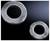 Two silver dental discs in various sizes on a black background. They display lateral grooves, suitable for mechanical applications.