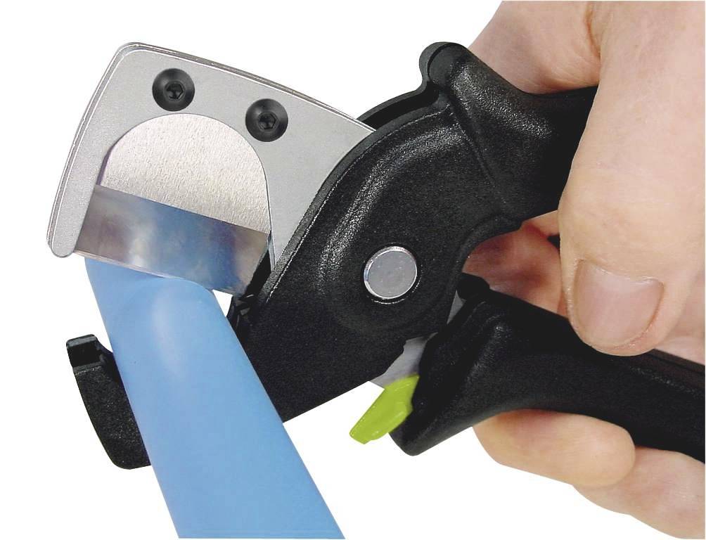 A hand is using a black plastic cutter to slice through a blue cable or pipe.