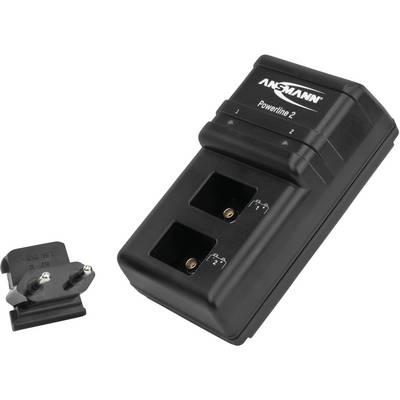 A black Ansmann charger with two battery charging slots. Beside it lies an interchangeable plug adapter.