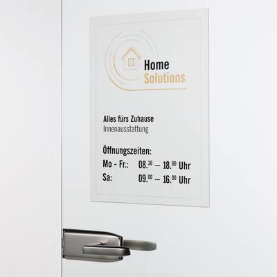 Sign on a door with the logo 'Home Solutions'. Text: 'Everything for the Home Interior. Opening Hours: Mon-Fri: 08:30-18:00, Sat: 09:00-16:00'.
