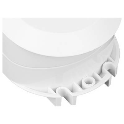 Close-up of a white plastic object with curved edges and ridges, possibly part of a mechanical device or household item.