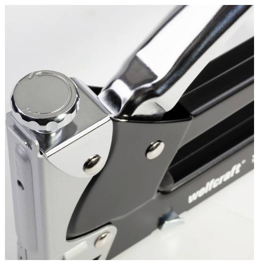 A close-up view of a metallic stapler with 'wolfcraft' branding on its side, showcasing its shiny silver and black finish.