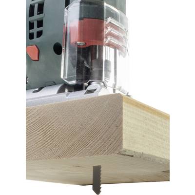 Close-up of a jigsaw cutting through a piece of wood. The saw blade is penetrating the wood from underneath.