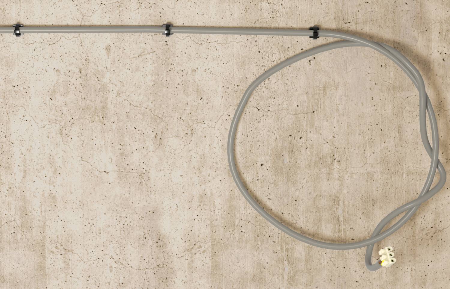 Loose gray cable with a white connector coiled against a stained concrete wall, attached to a horizontal metal pipe.