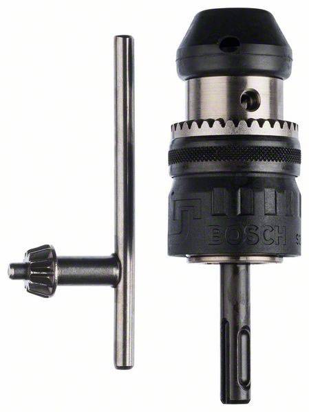 Black and silver drill chuck with toothed rim and small metal key positioned to the left, standing upright, against a white background.