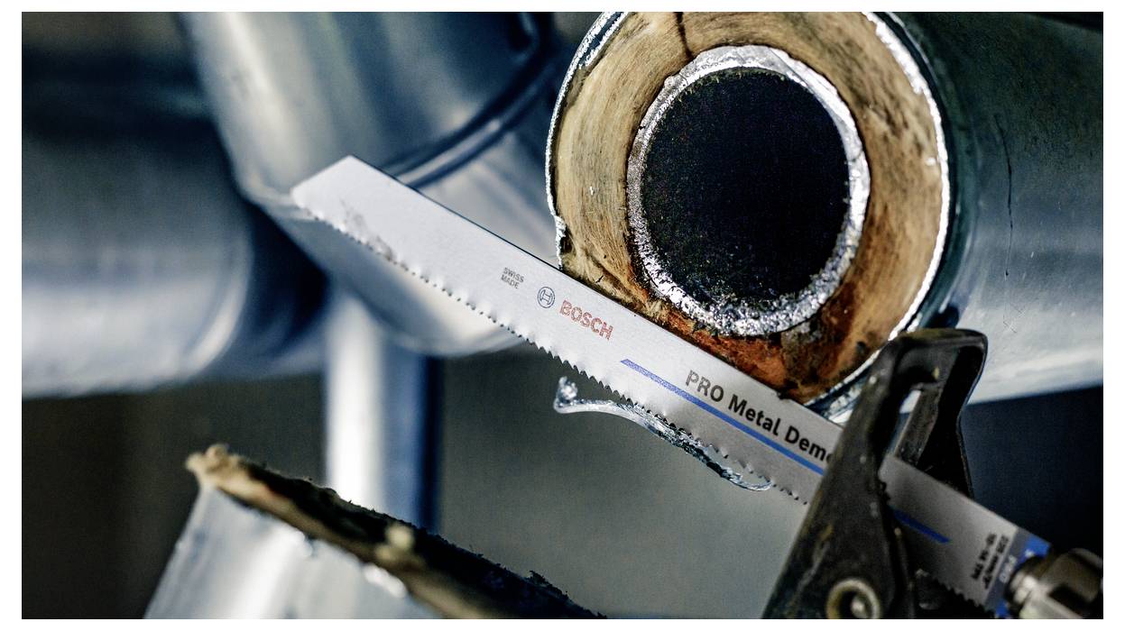 A metal saw blade cutting through a thick metal pipe, highlighting its cutting precision and strength.