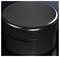 Black round container on a dark background, with a smooth surface and glossy finish.