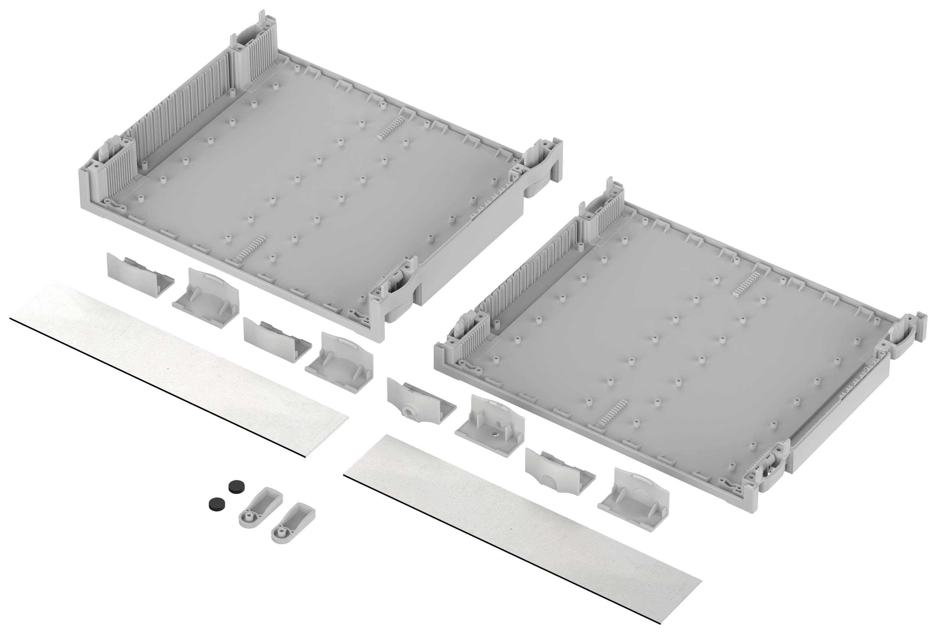 Two grey plastic parts with side clips, alongside smaller fastening elements and strips. Used for mounting or grouping components.