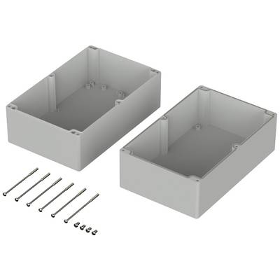 Two grey plastic housings for electrical devices, lying open side by side. Several screws in two sizes are placed in front of them.