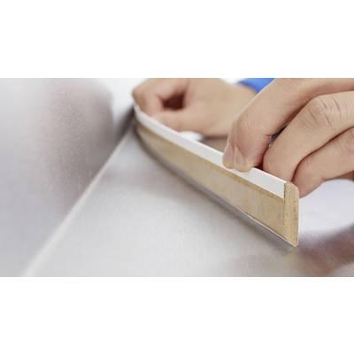 Hands of a person are applying a self-adhesive sealing tape to a metal surface to ensure a seal.