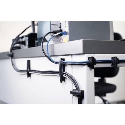 Cable management at a desk, where cables are neatly secured with clips along the desk's edge.