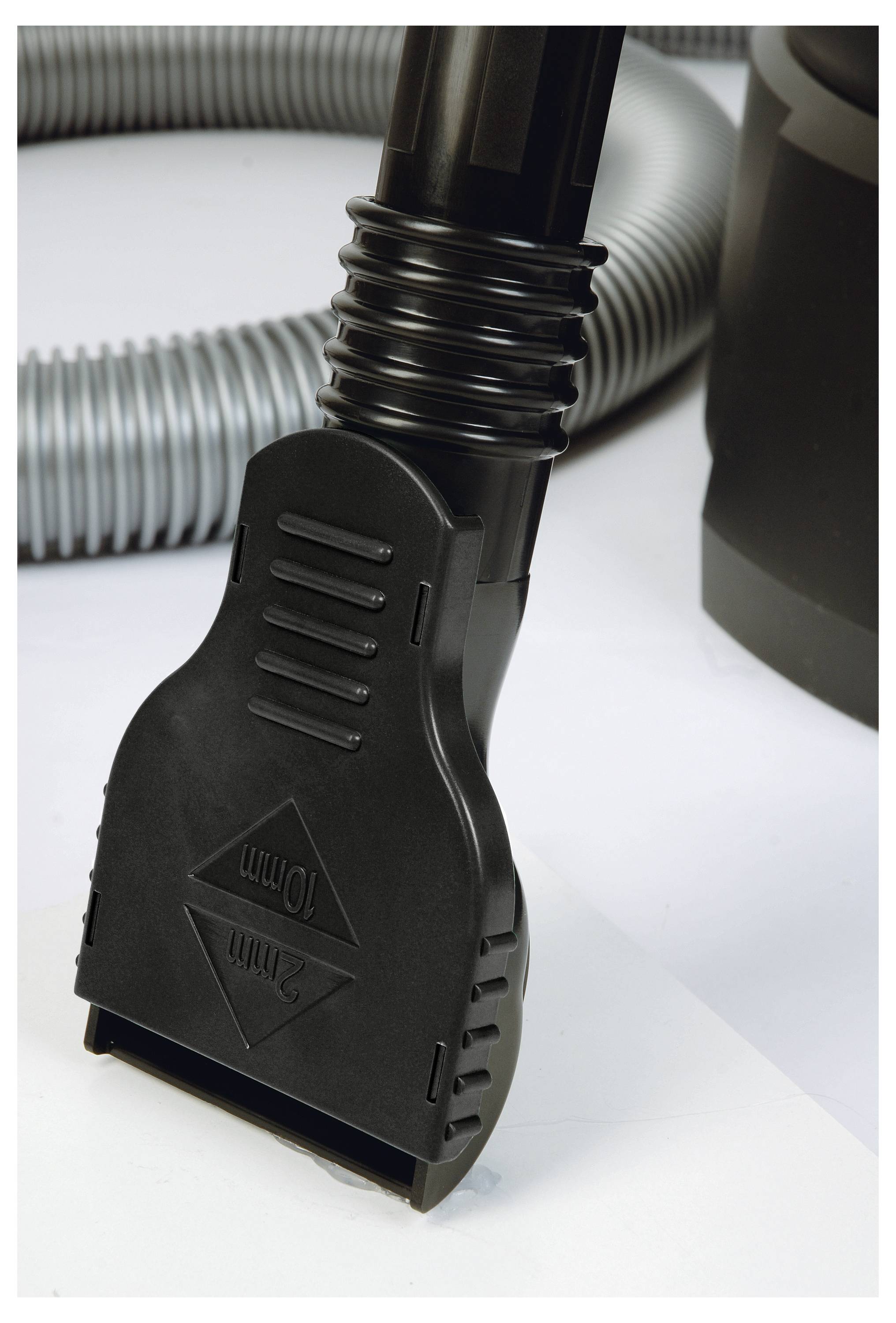 A close-up of a vacuum cleaner hose with a black plastic attachment reading '10mm' against a light background.