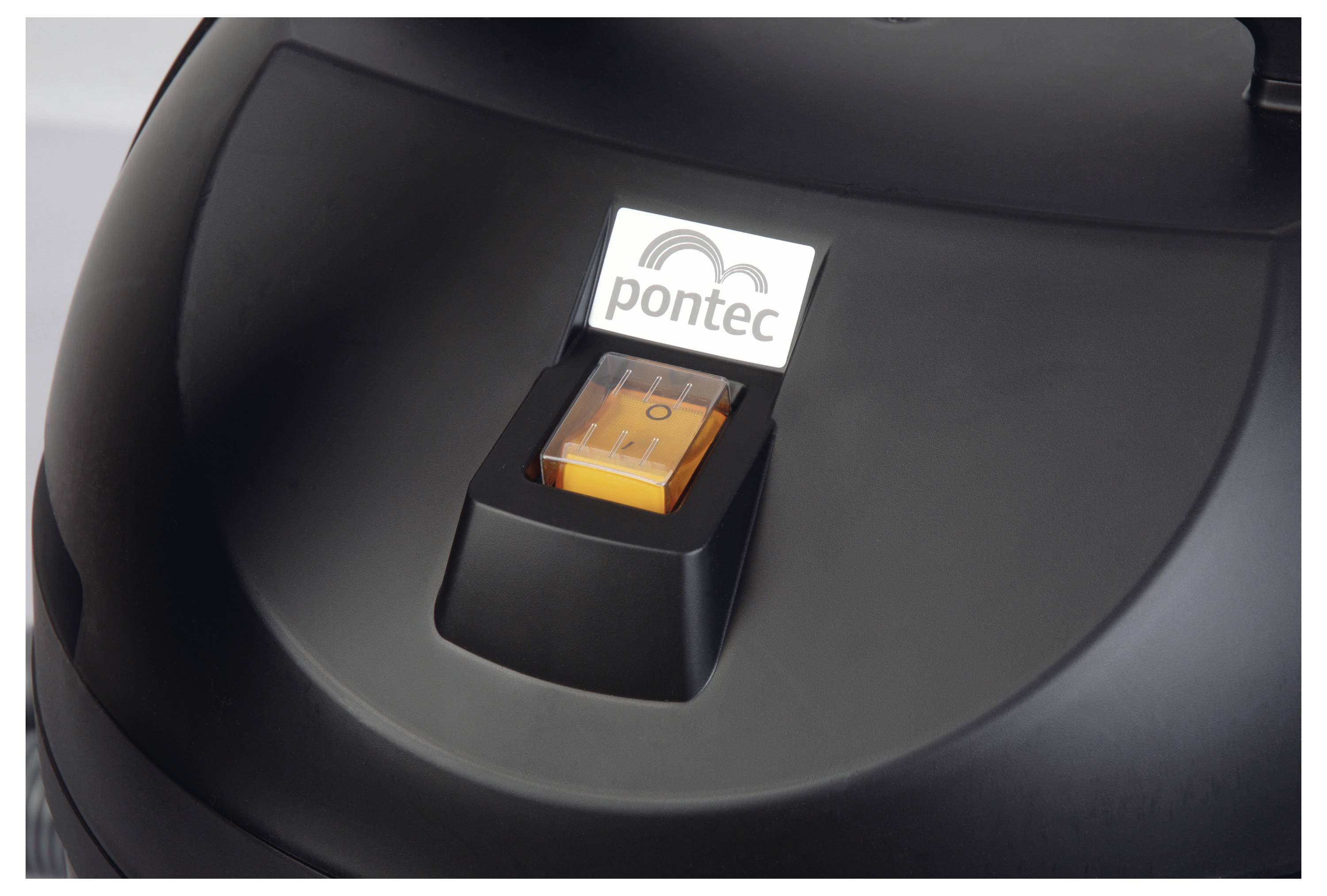 A close-up of a black lid with an orange switch and a logo saying 'pontec' on top. The object appears to be part of a device or machine.