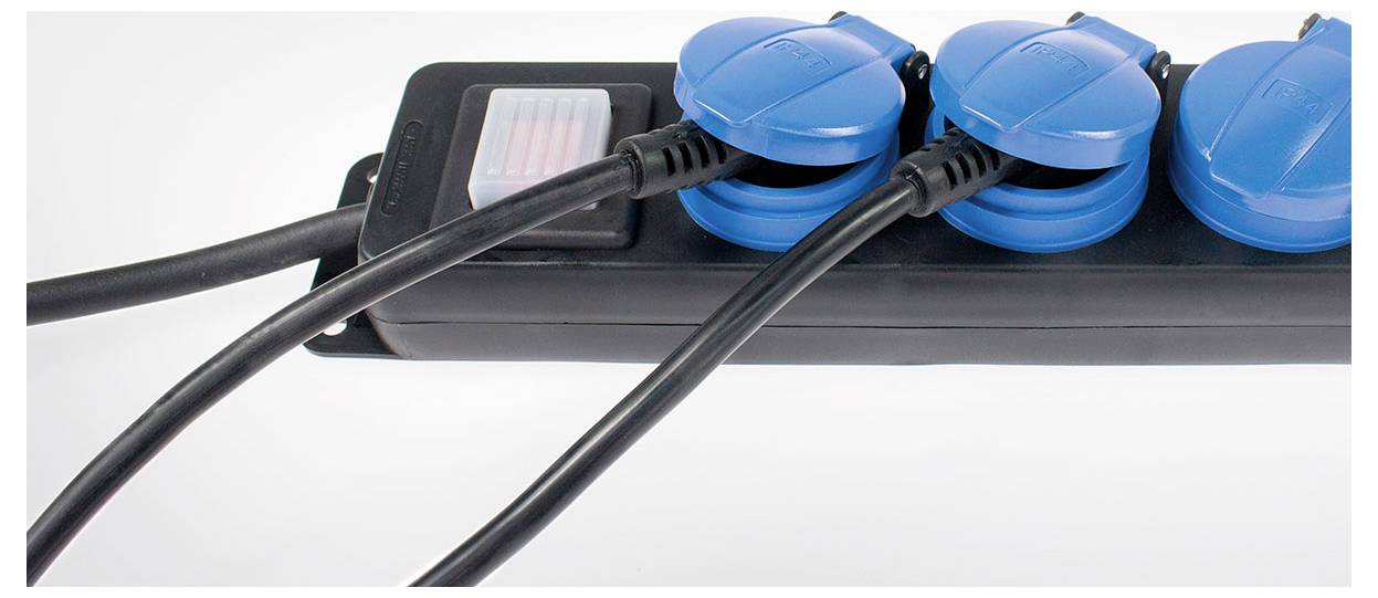 Triple socket with blue covers and black cables in a black strip, suitable for multiple electrical connections.