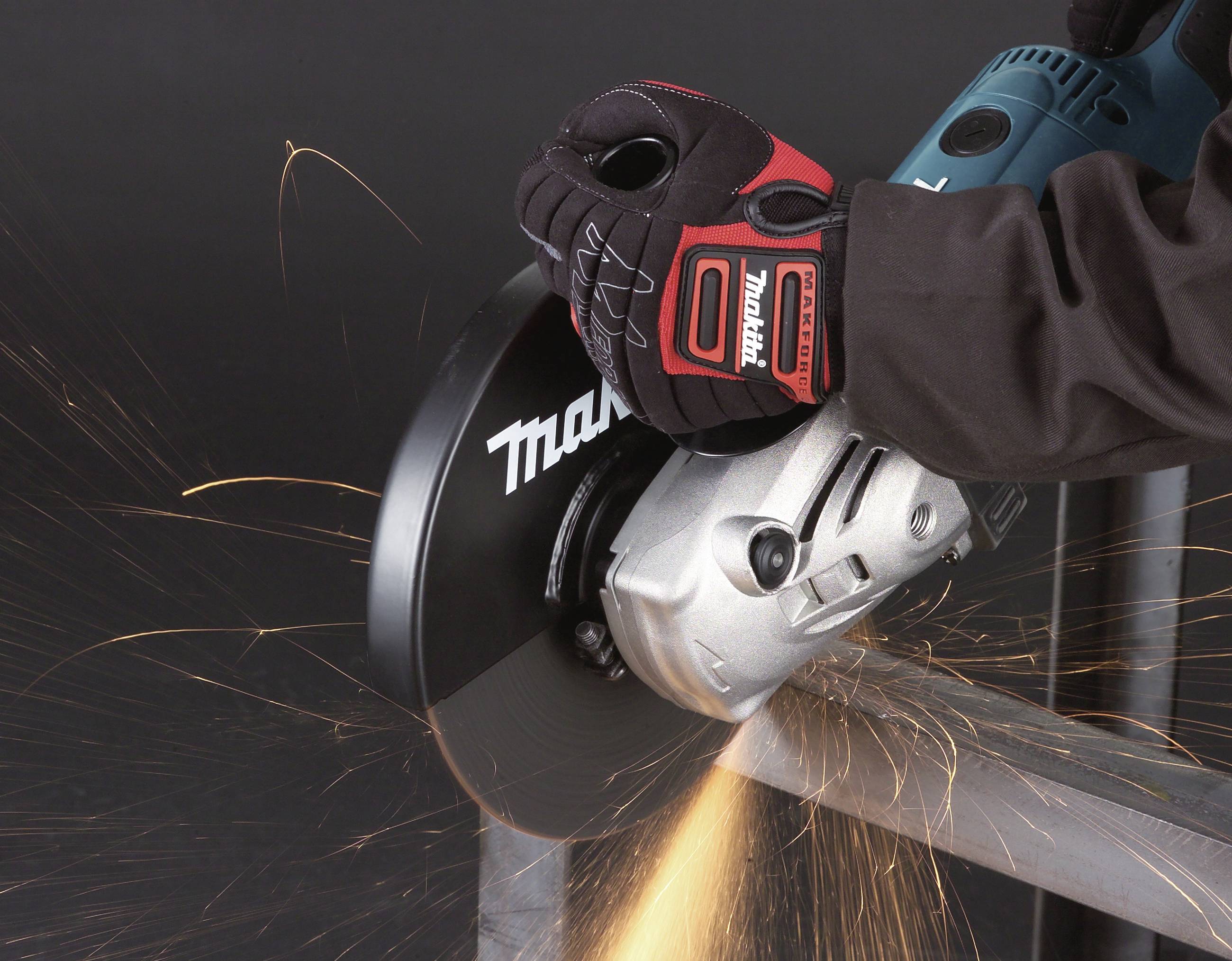 A person wearing gloves is using an angle grinder to cut metal, with sparks flying.
