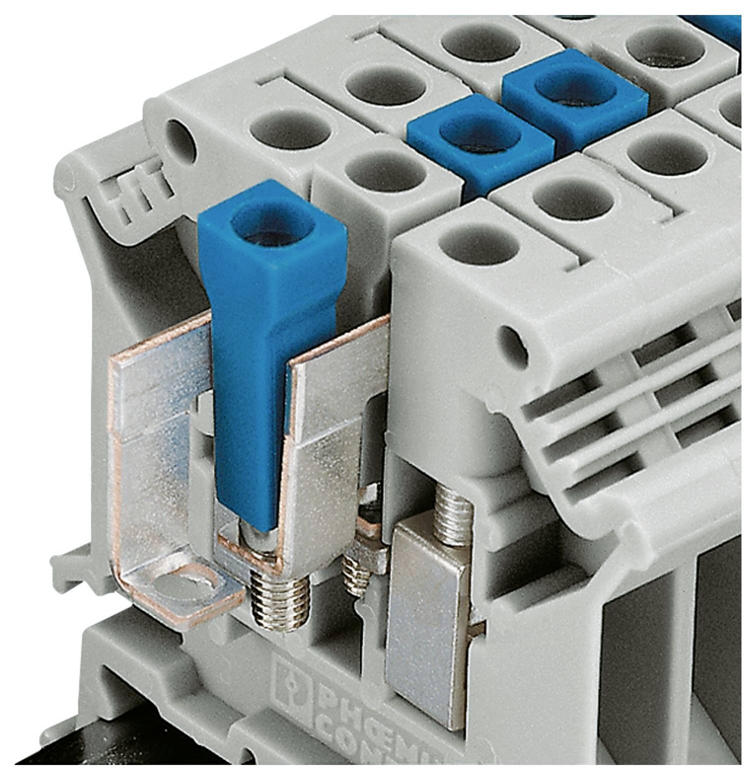 'Gray and blue terminal block with screw connections for securing electrical wires.'
