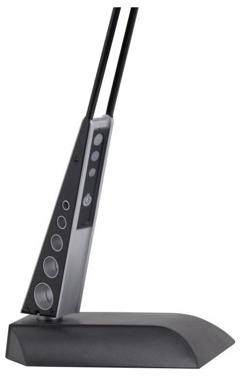 A black electronic device with control buttons and circular openings, likely a microphone or speaker system, resting on a sloped base.