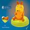 An orange mouse-shaped figure with a touch sensor on a green base, recommended by young parents.