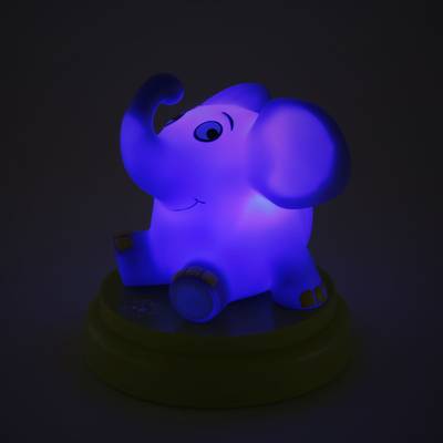 A luminous night light in the shape of a cheerful, sitting elephant on a round base, emits a blue light.