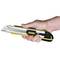 A hand is holding a yellow carpet knife with the 'Stanley' trademark.