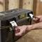 A person opens a black 'Stanley Fatmax' toolbox in a workshop environment.