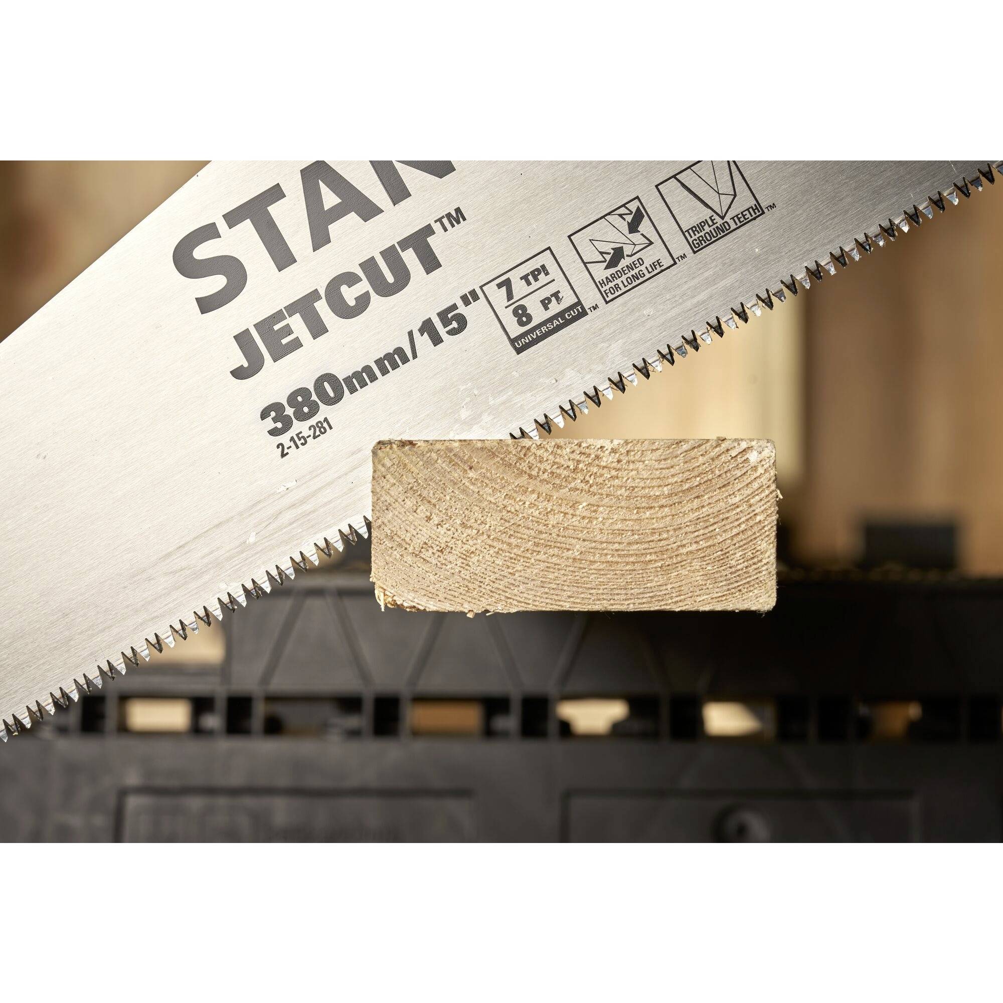 A handsaw with the inscription 'JETCUT' is cutting through a piece of wood resting on a black plastic stand.