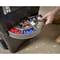 A hand pulls out a drawer with sorted screws and wall plugs in various colours and sizes from a toolbox.