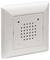 A white wall-mounted speaker or intercom with a square perforated grille at the center, typically used for audio communication.