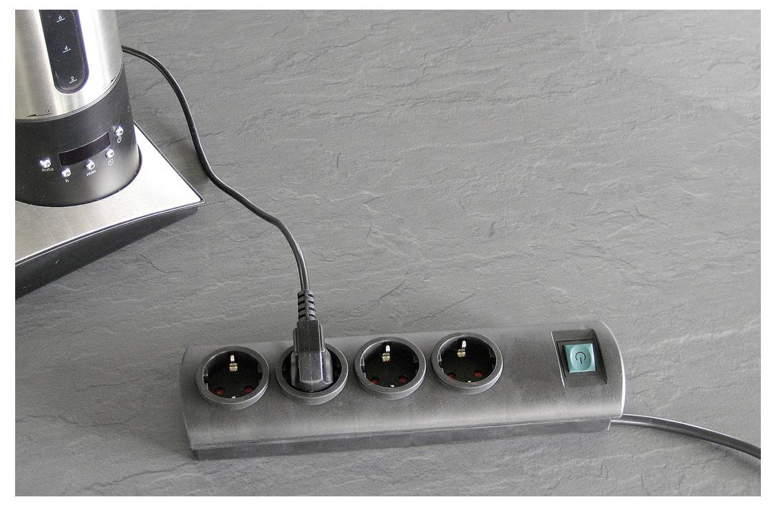 Power strip with four round sockets and a teal on/off switch, with one plug inserted and a kettle base nearby.