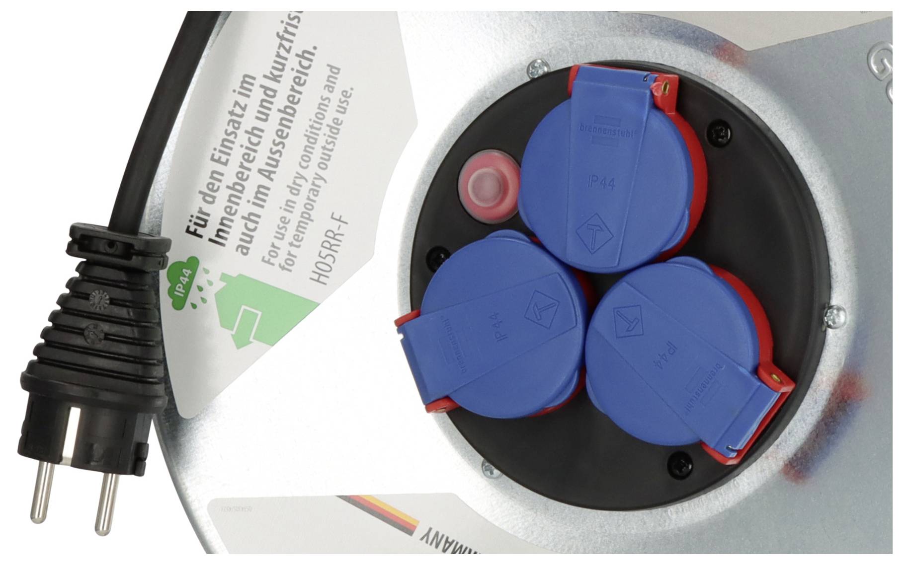 'Close-up of a power cable reel with three sockets and a plug, featuring German text indicating usage and safety information.'