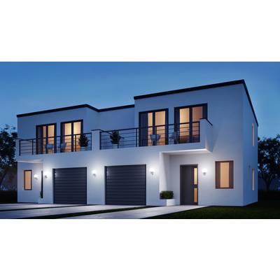 A modern two-storey house in the evening; white facade, large windows, balconies with plants, double garage, illuminated at dusk.