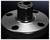 A metallic flat disc with a cylindrical extension in the centre and four holes, likely a component or connector.