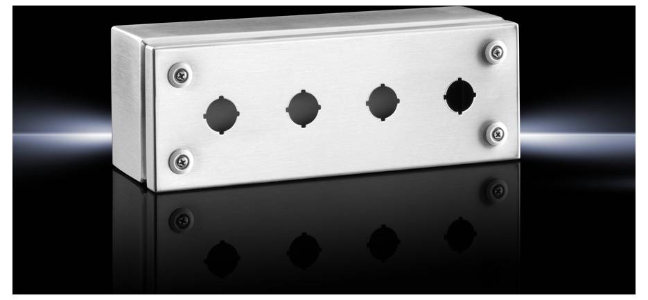 Metal enclosure with four round openings on a reflective black surface and dark background.