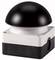 Black mushroom push button on white, angular base, primarily used for industrial emergency stop applications.