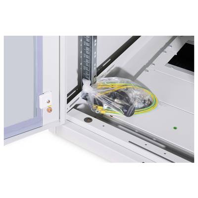 Plastic bag containing cables and mounting accessories lies inside an opened electrical control cabinet.