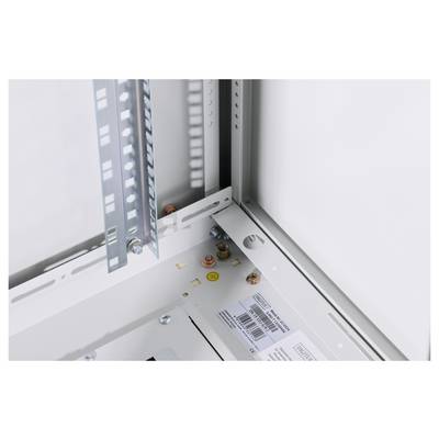 Metal frame of an electrical distribution cabinet with screws and mounting brackets, showing the internal construction for cable installation.