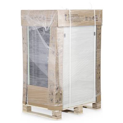 A packaged household appliance on a wooden pallet, wrapped in clear plastic and cardboard. Pictograms show handling instructions.