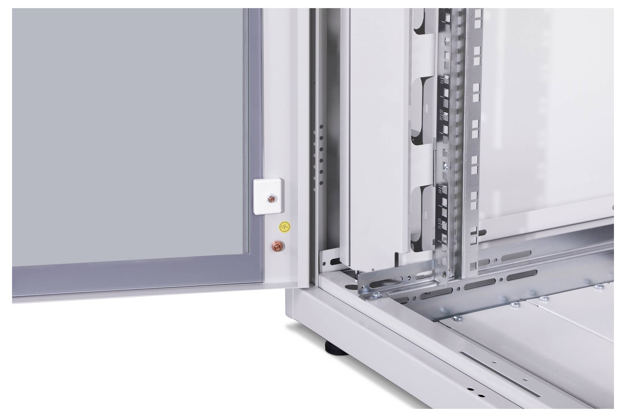 An open electrical cabinet reveals its interior with metallic mounting brackets and rails. On the left, a grey door with a lock and signal lights.