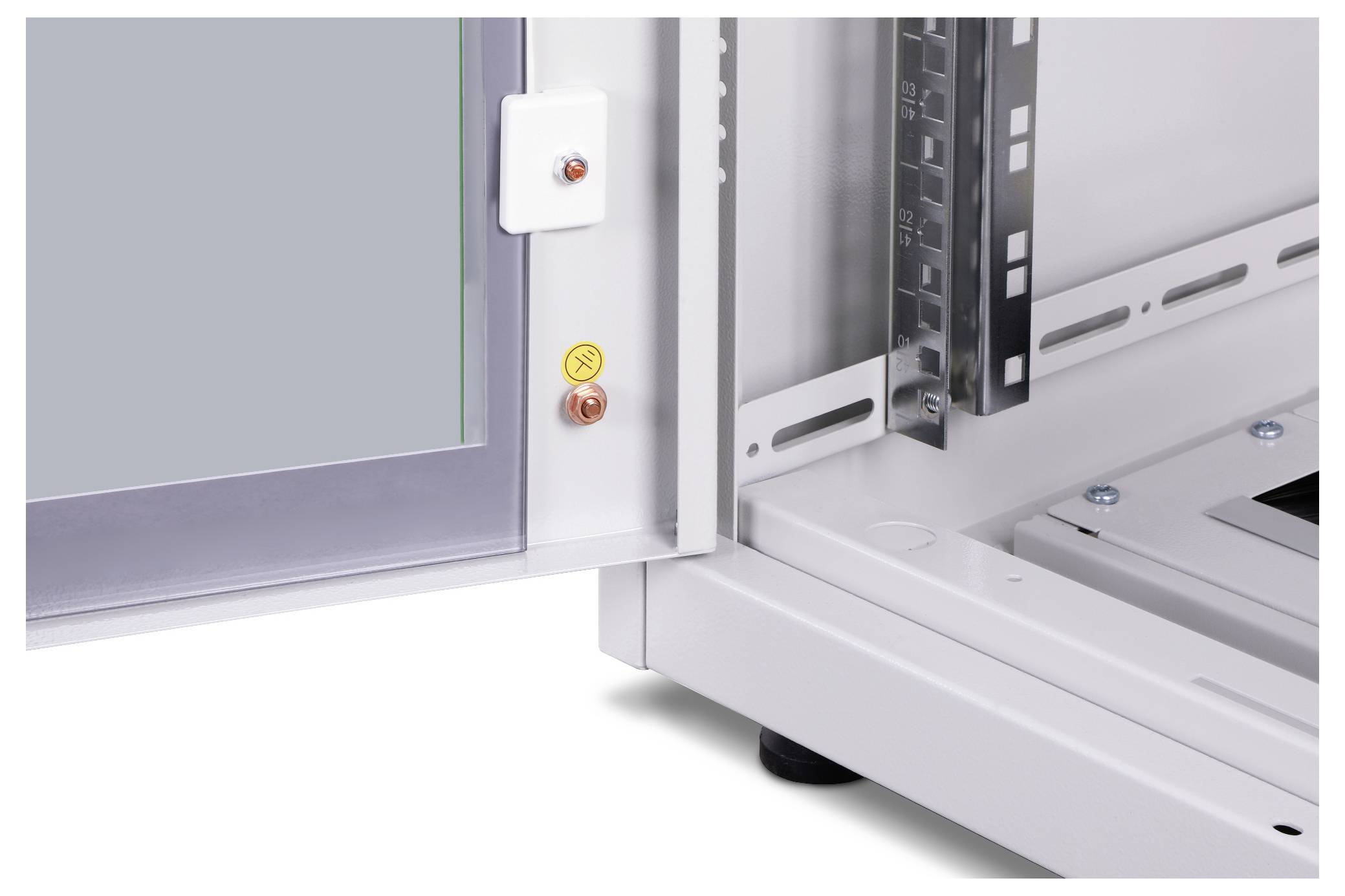An open metal enclosure reveals parts of an electrical cabinet with screwed components and levelling feet against a white background.